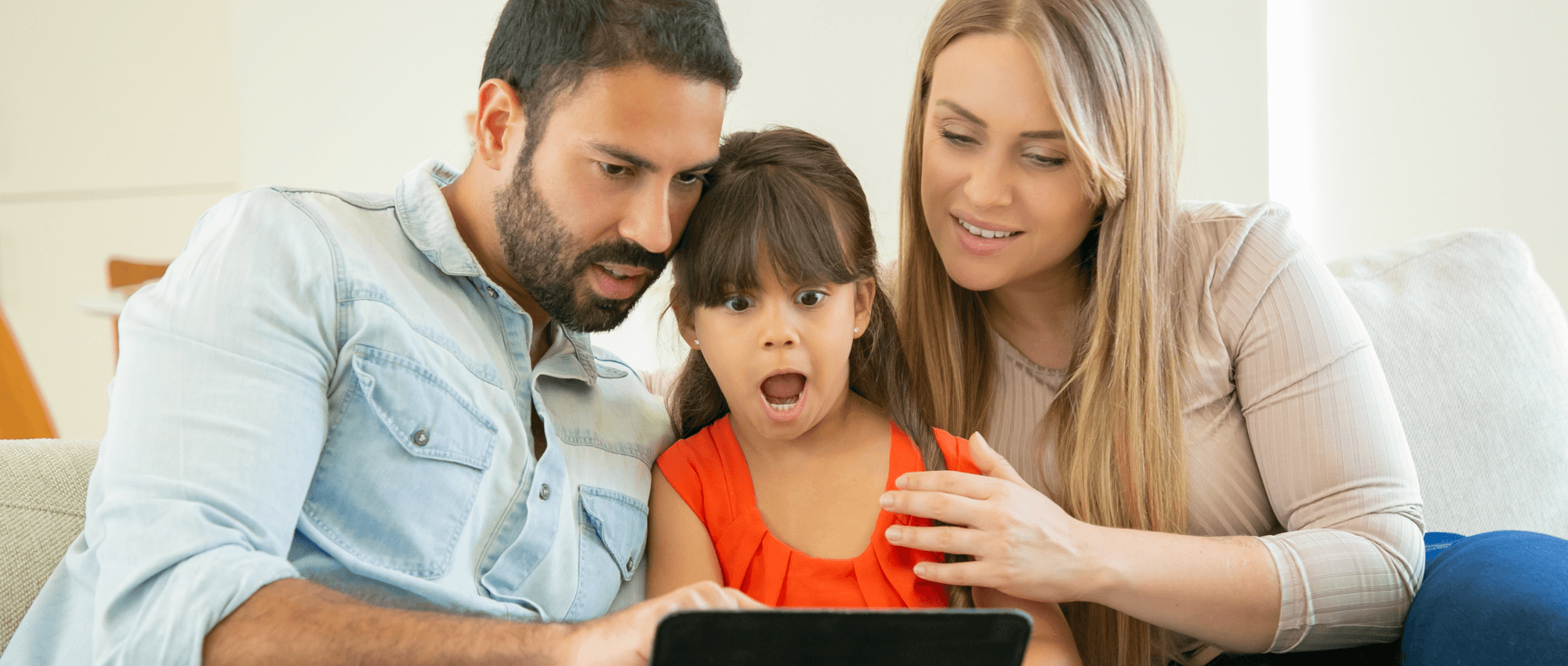parents and child on tablet