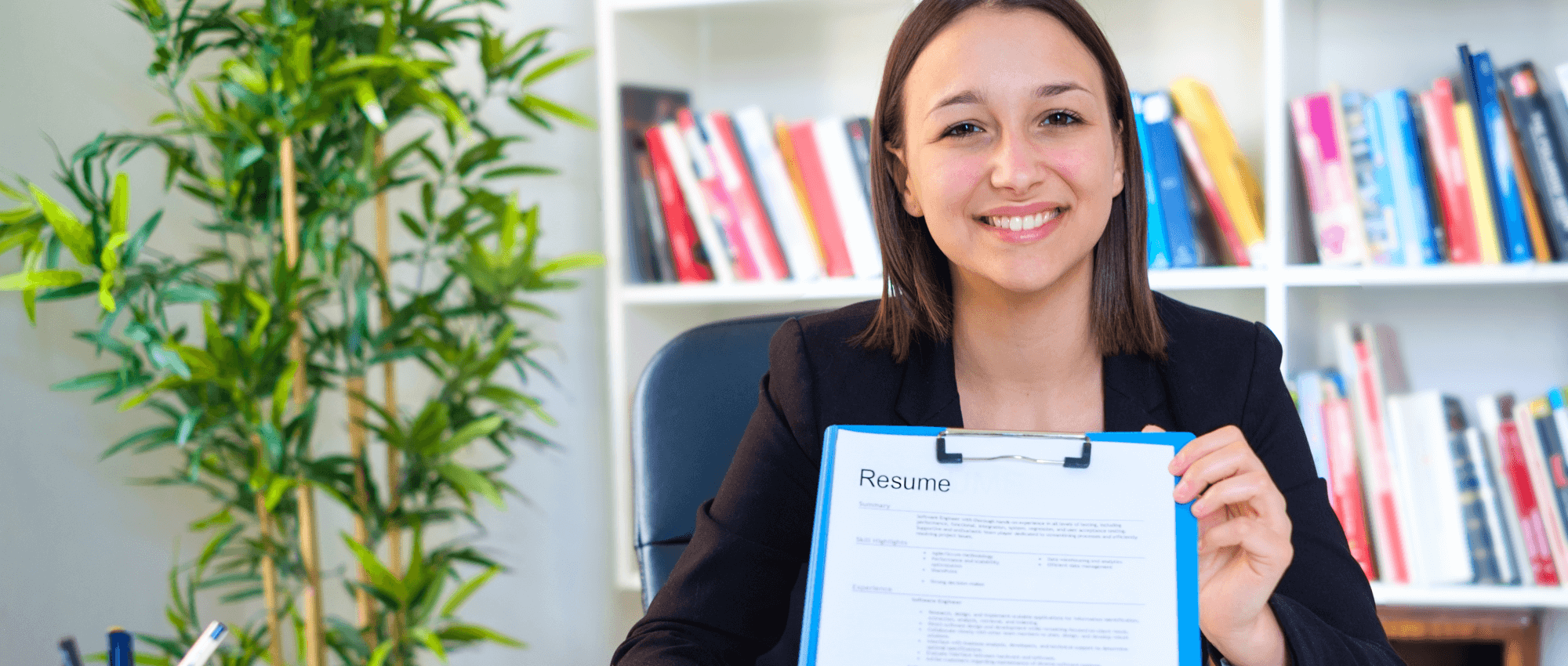 woman holding resume and smiling