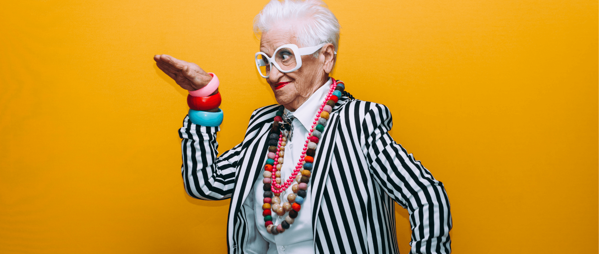 elderly woman in striped suit and jewelry