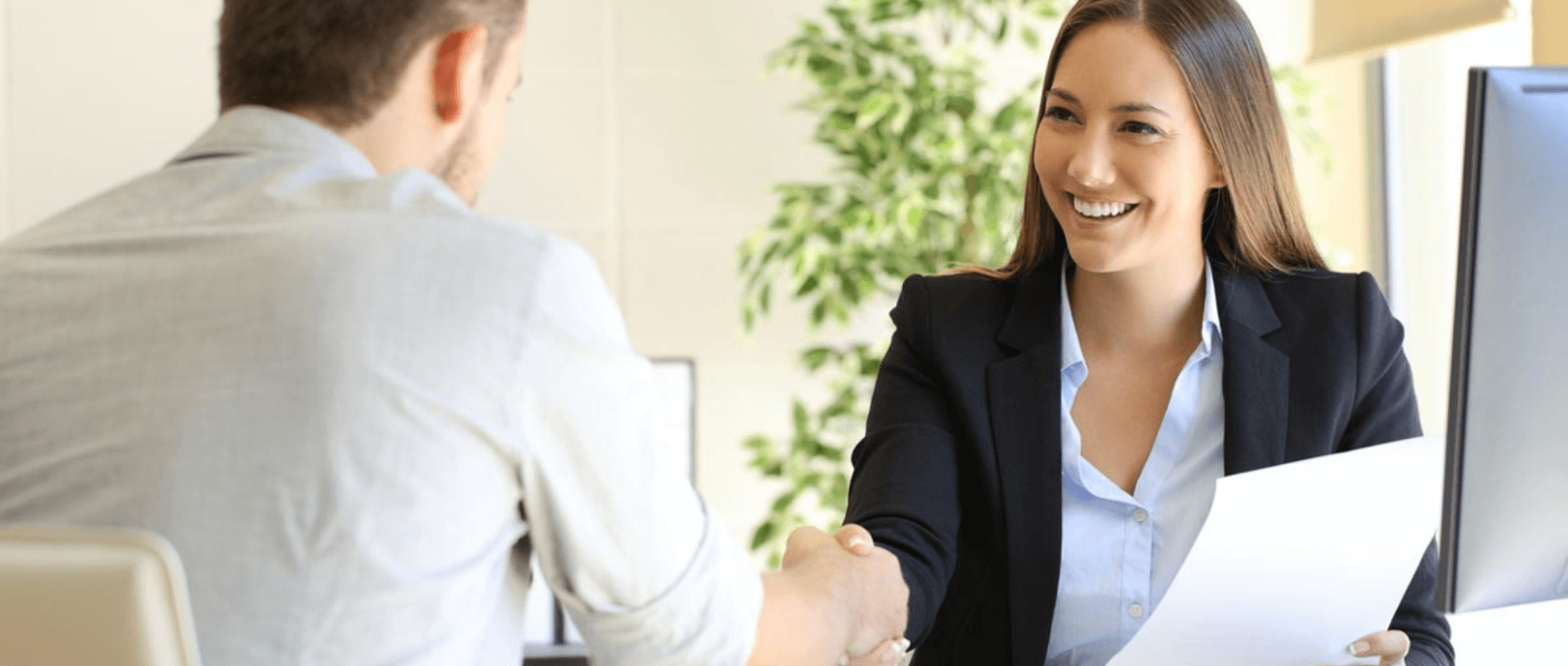 man and woman shaking hands at interview