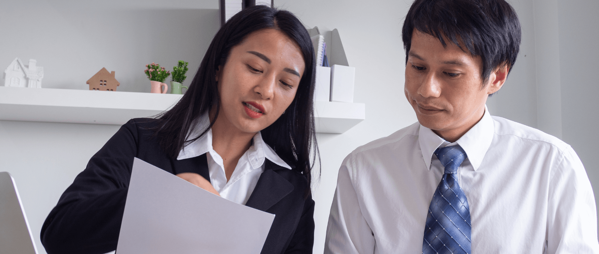 man and woman talking in office
