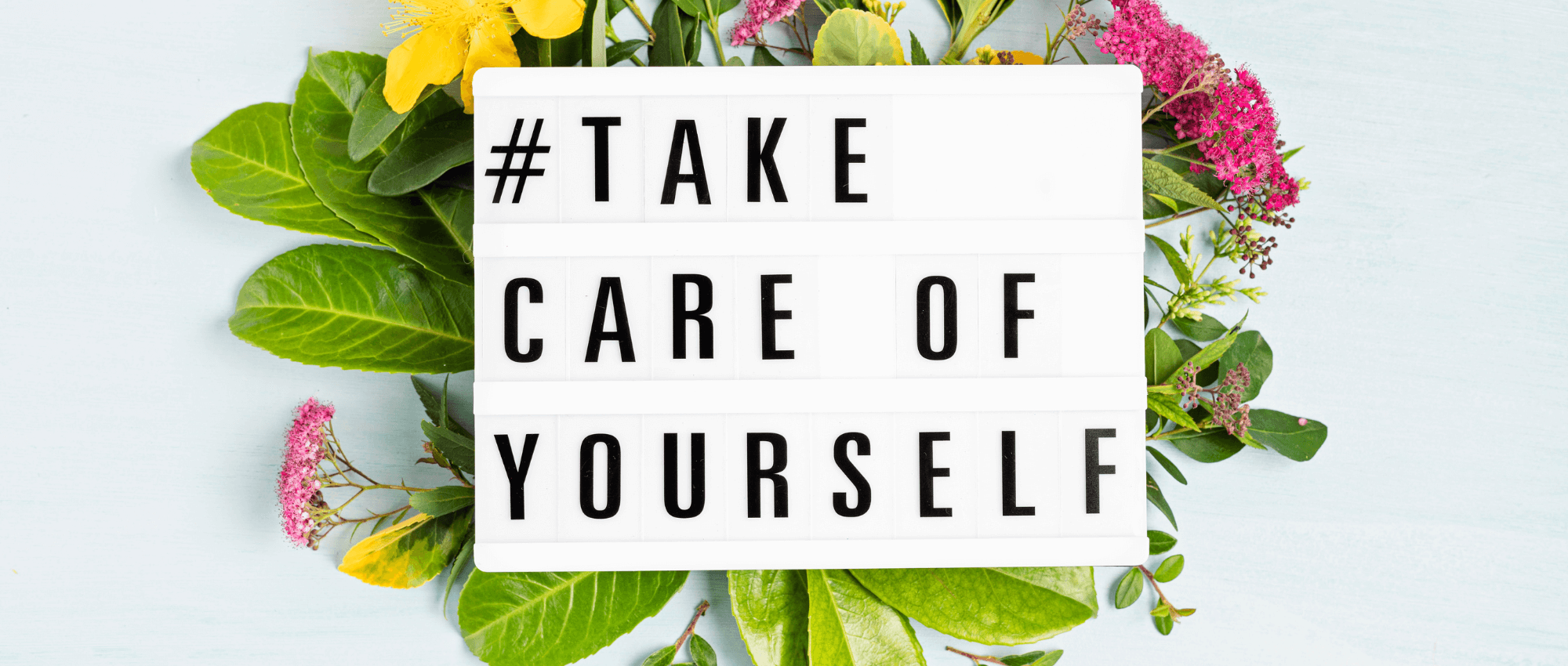 take care of yourself sign with flowers