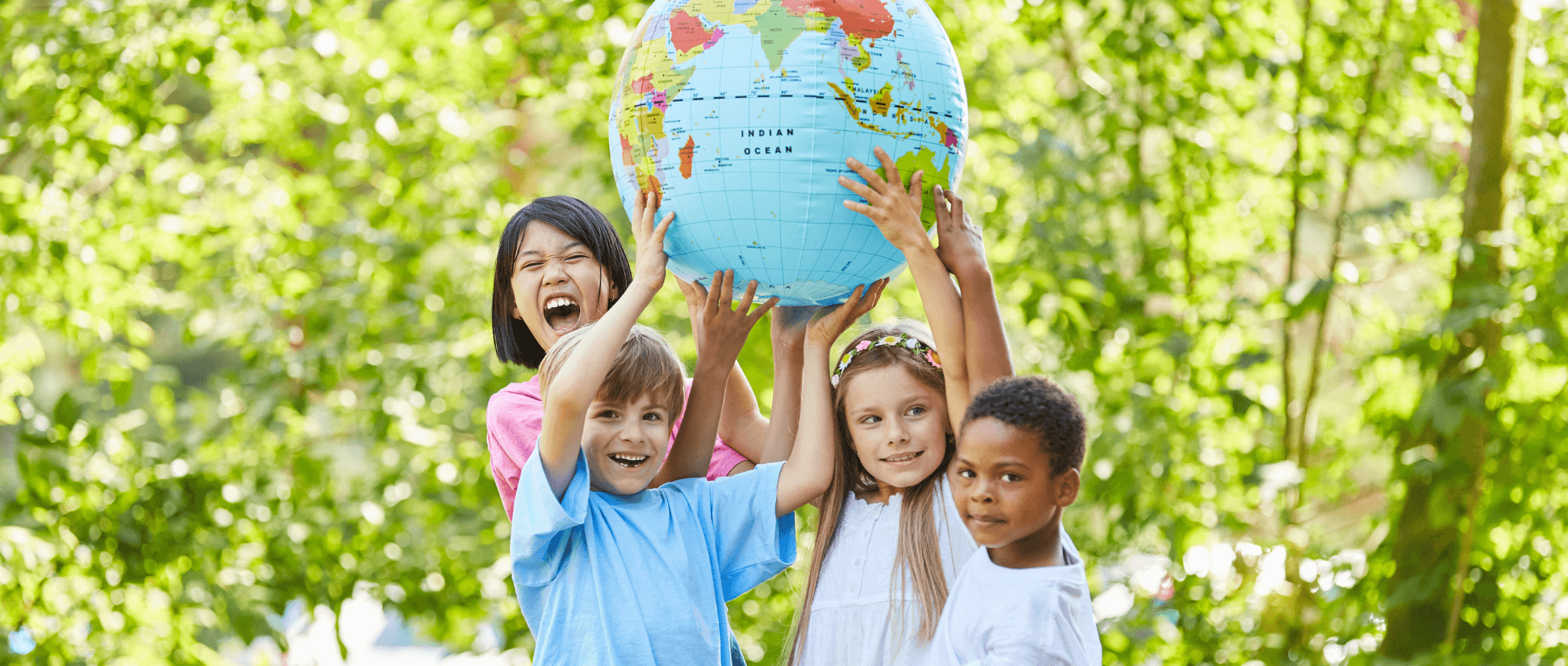 group of children holding a globe
