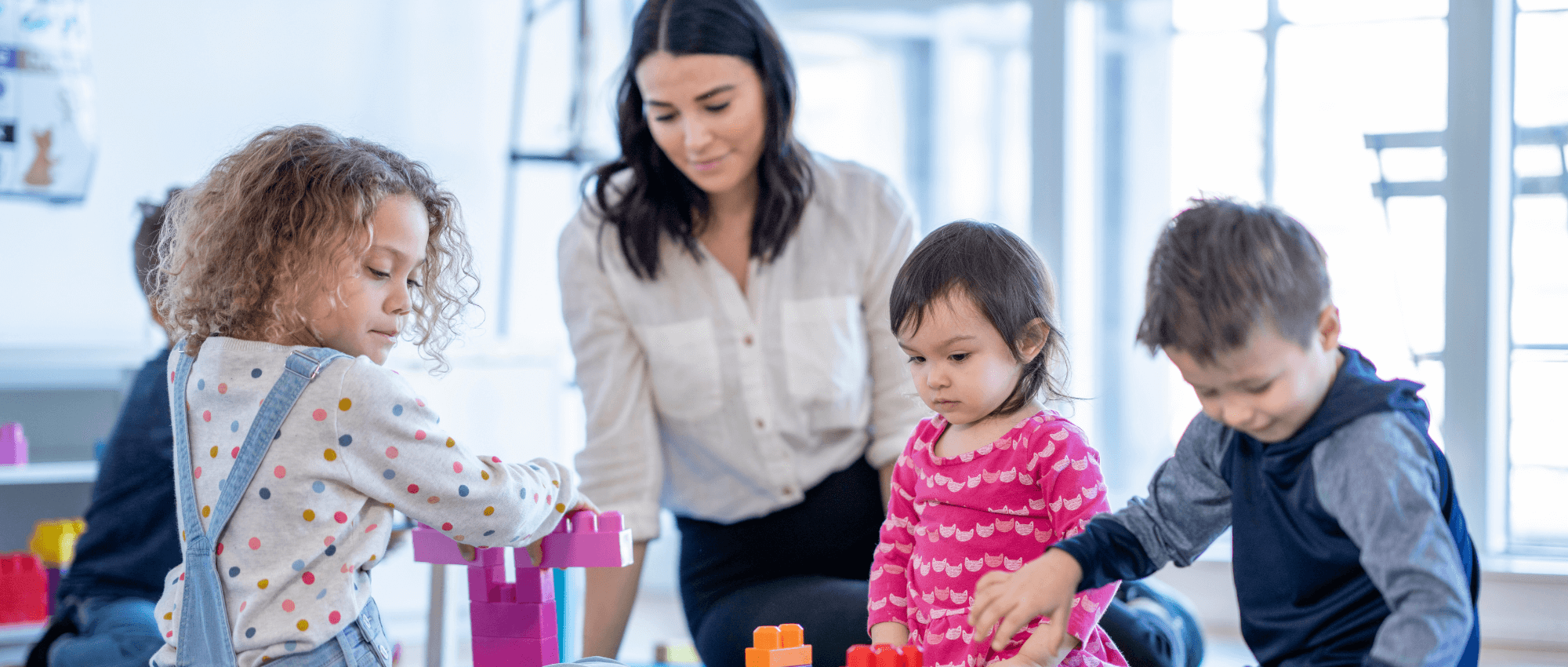 woman with young children in childcare