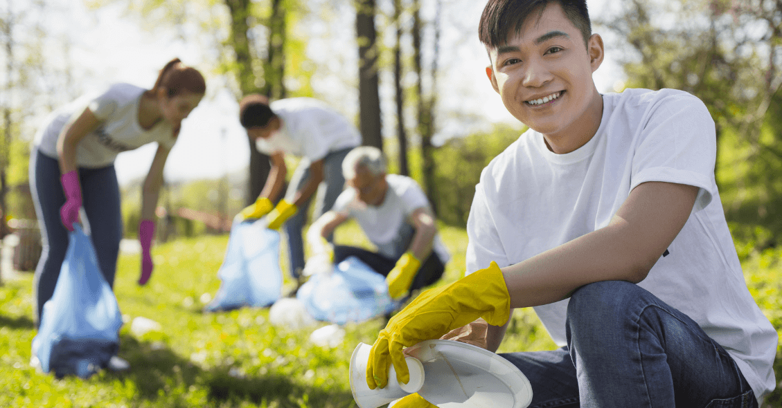 young-man-volunteer-giving-back-community