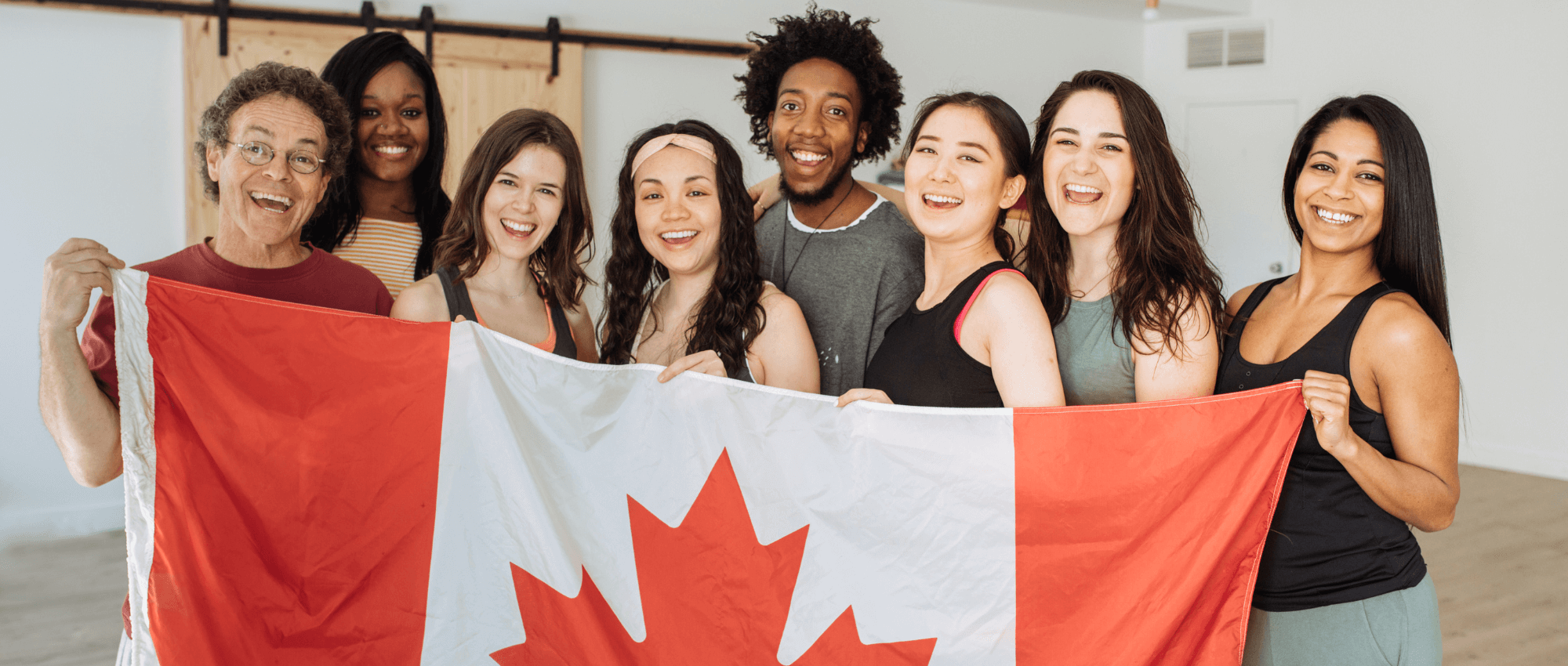 A group of dancers holding the Canadian flag