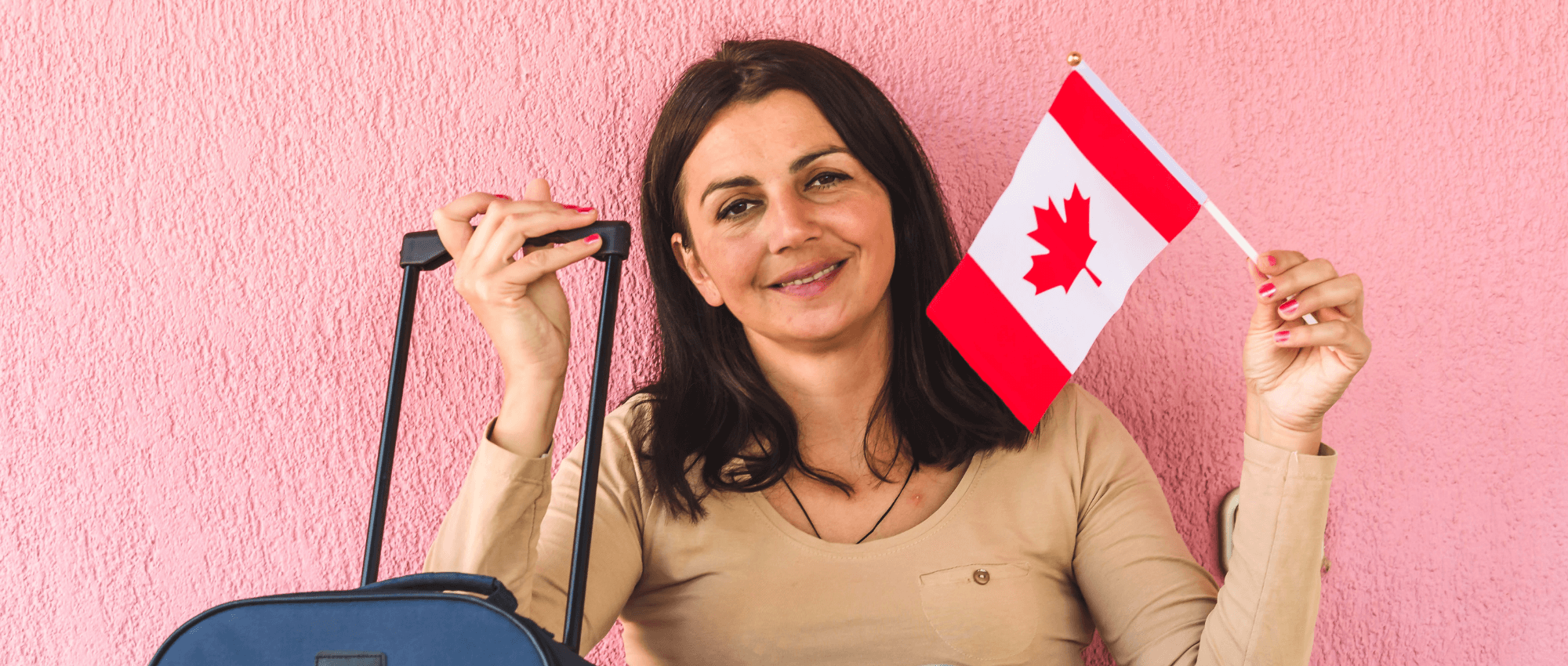 An immigrant holding a Canadian flag