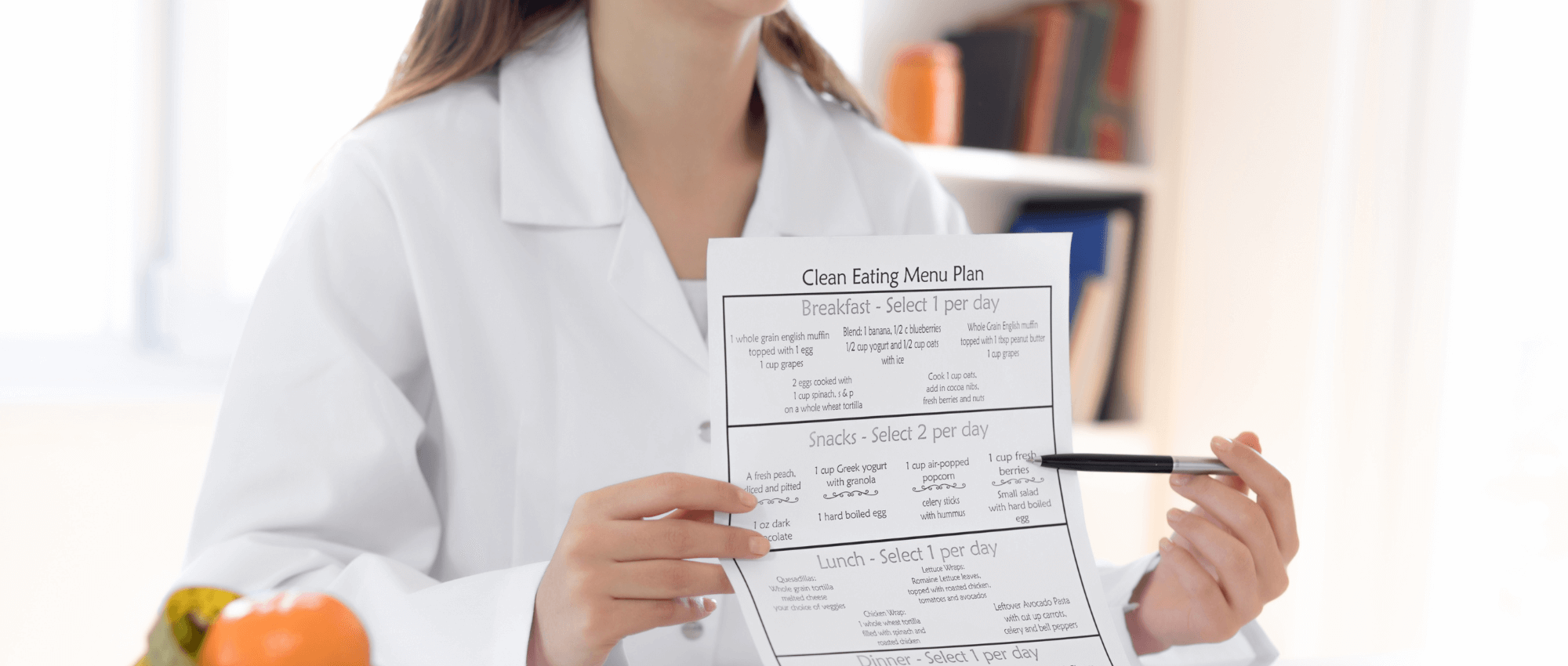 nutritionist holding up clean eating menu plan