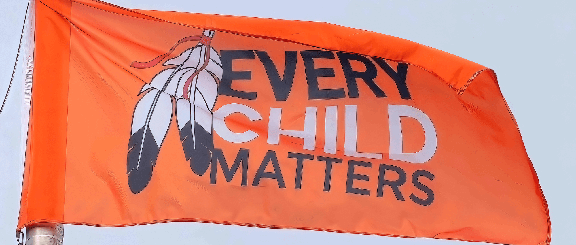 An orange flag with EVERY CHILD MATTERS written on it