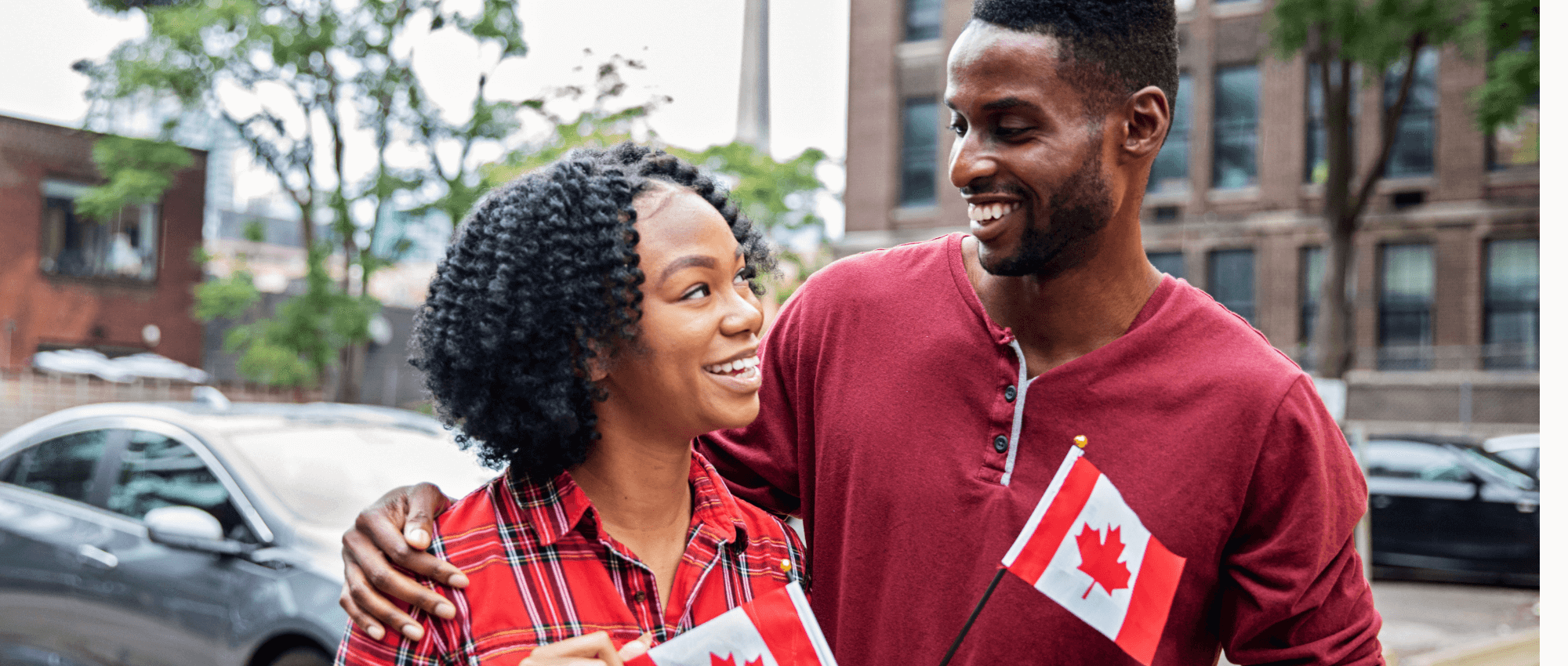 Two couples holding the Canadian flag